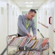 A records clerk sorts through records on a trolley.