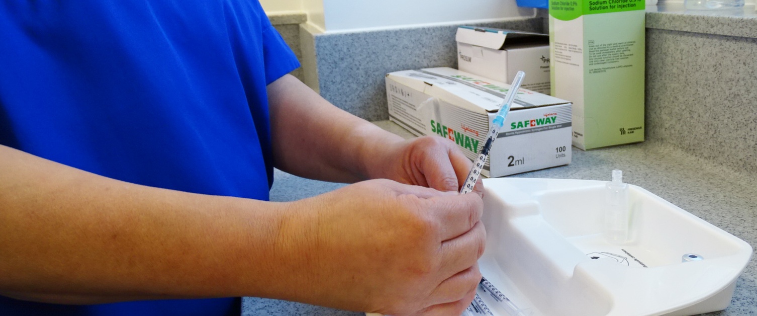 An image of a nurse preparing the vaccine