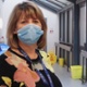 Two people wearing face masks inside a hospital corridor