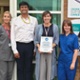 Image shows a group of clinicians outside a hospital building.