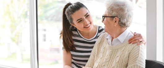 A girl hugging a woman