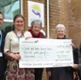 Image shows a group of people holding a large cheque.