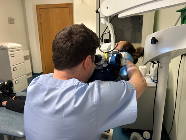 Timothy looking into a woman