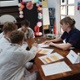 A group of children working on a school project with a nurse
