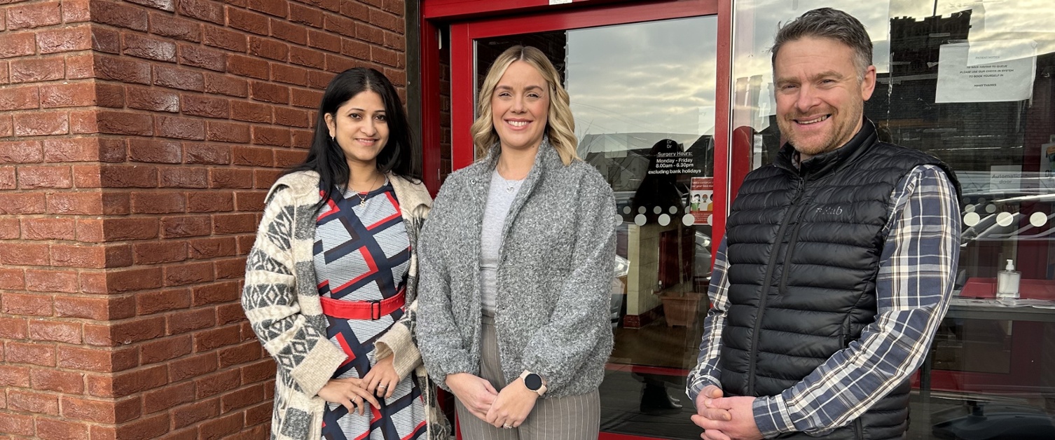 Sowndarya, Emma and Arron stood outside a GP practice