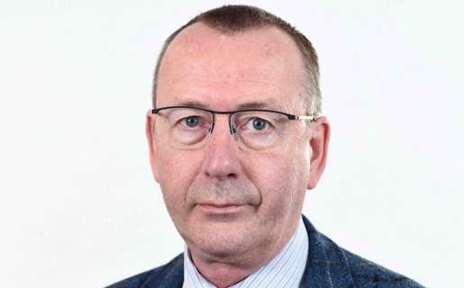 Image shows a man looking into the camera.