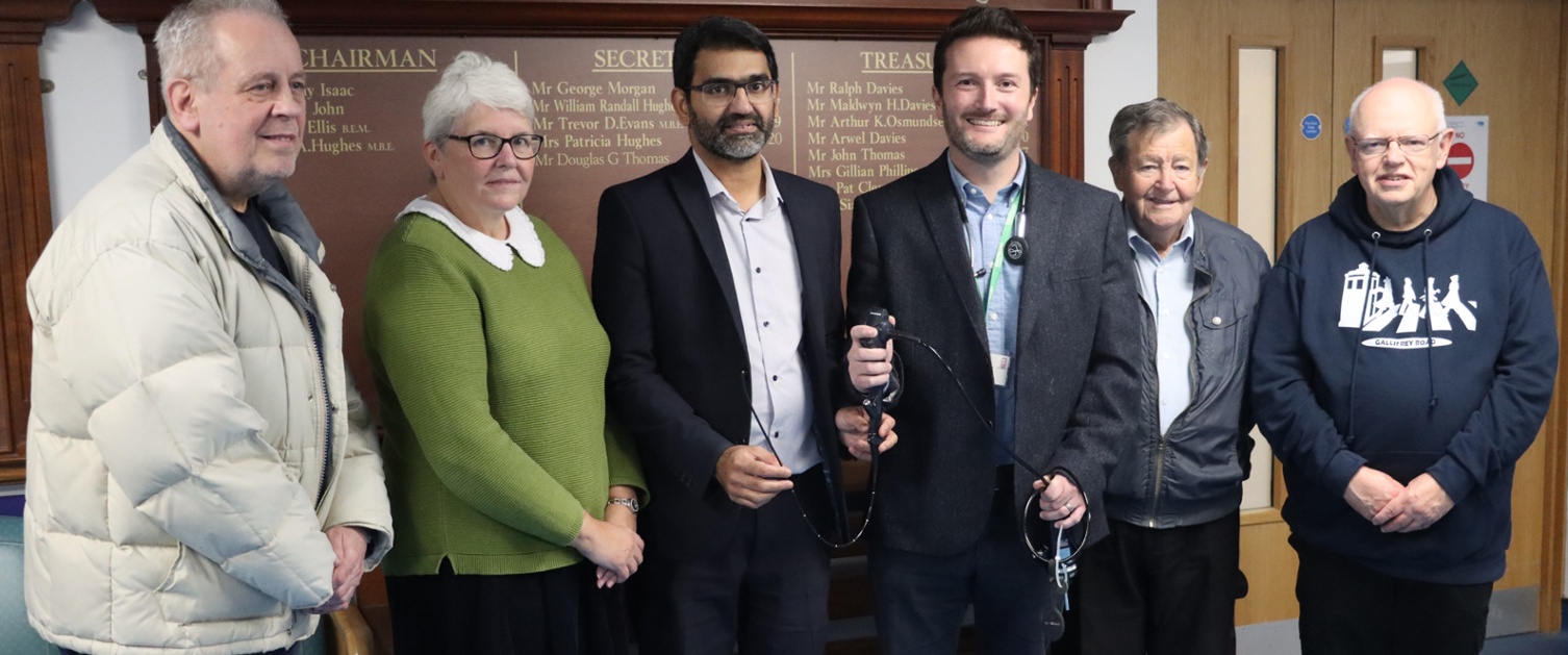 Two doctors holding a piece of medical equipment called a bronchoscope