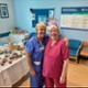 Image shows two women standing in front of a table