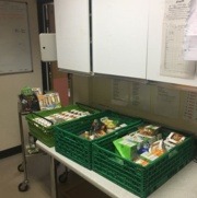 Image shows two crates full of sandwiches and other food.