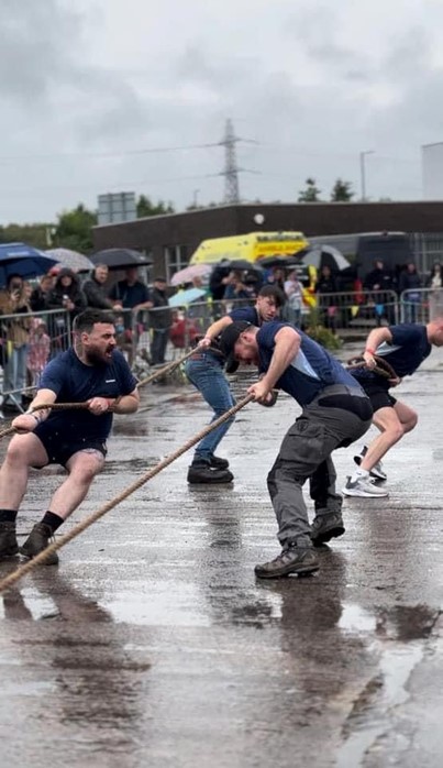 Image shows a group of people during a truck pull event.