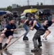 Image shows a group of people during a truck pull event.