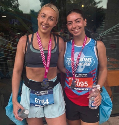 An image of Rachel Wales, with a friend, after completing Swansea Half Marathon.