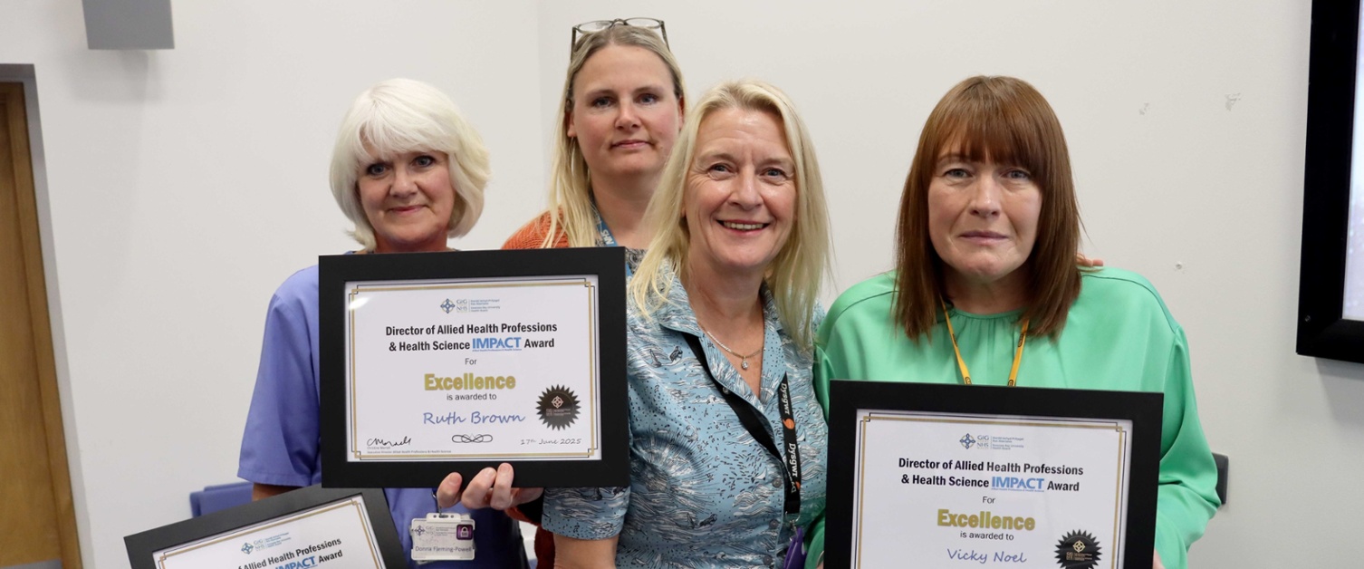 Group image with reward recipients holding their certificates.
