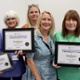 Group image with reward recipients holding their certificates.