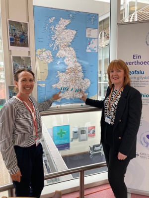 Image shows two women pointing to a map of Great Britain