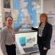Image shows two women pointing to a map of Great Britain
