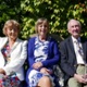 Image shows three people sitting on a bench.