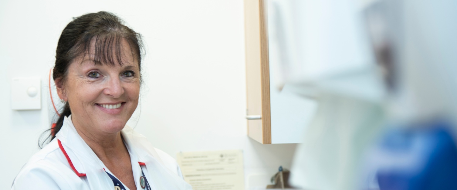 A nurse smiling at the camera