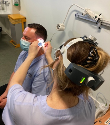 Image shows a man undergoing a hearing test