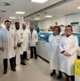 Image shows a group of people standing in a laboratory