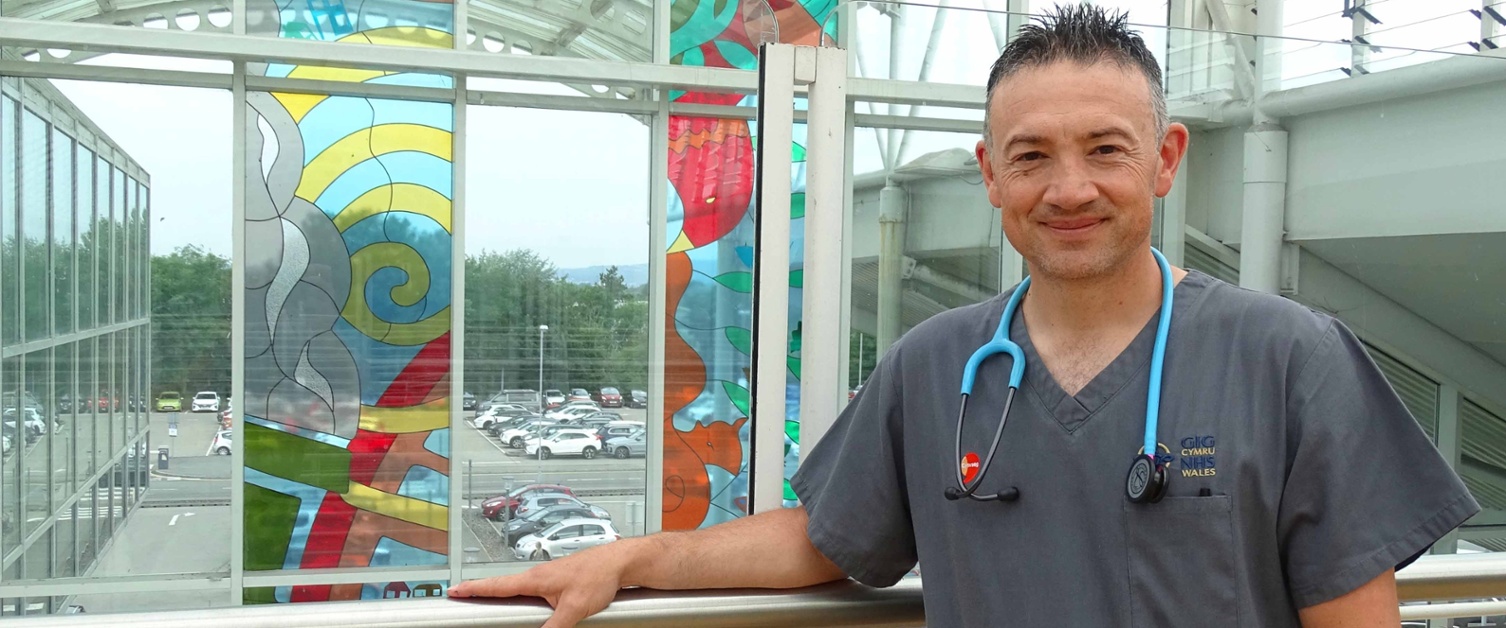 Image shows a nurse in a hospital atrium.