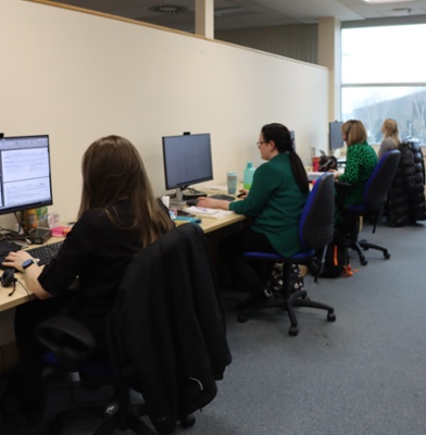 An image of Kirsty Joseph - Digital Project Officer, Yvette Lloyd - Product Specialist. Nerys James - Digital Programme Manager, and Rebecca Jelley - Senior Project Manager all working on projects at their desks.