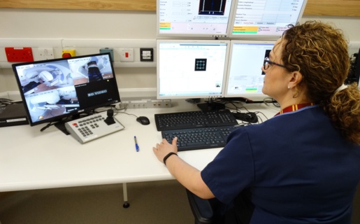 A radiographer works at a computer.