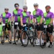 A group of cyclists smiling and getting ready to ride off