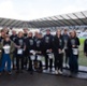 A large group of volunteers with charity donation buckets