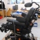 A workshop with a wheelchair that is being worked on.
