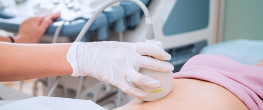 A pregnant woman having an ultrasound scan