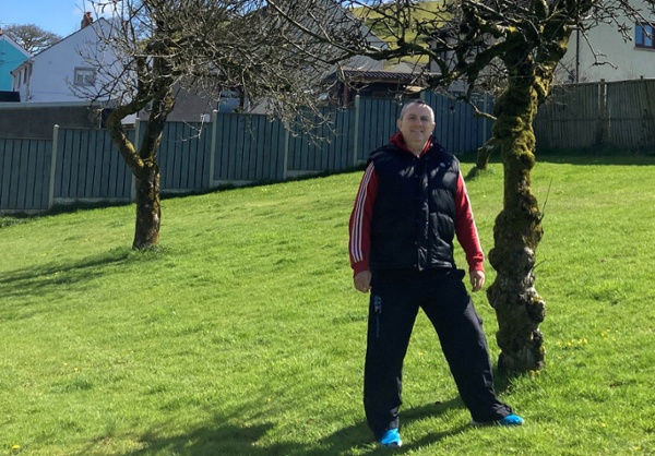 Image shows a man standing in a large garden