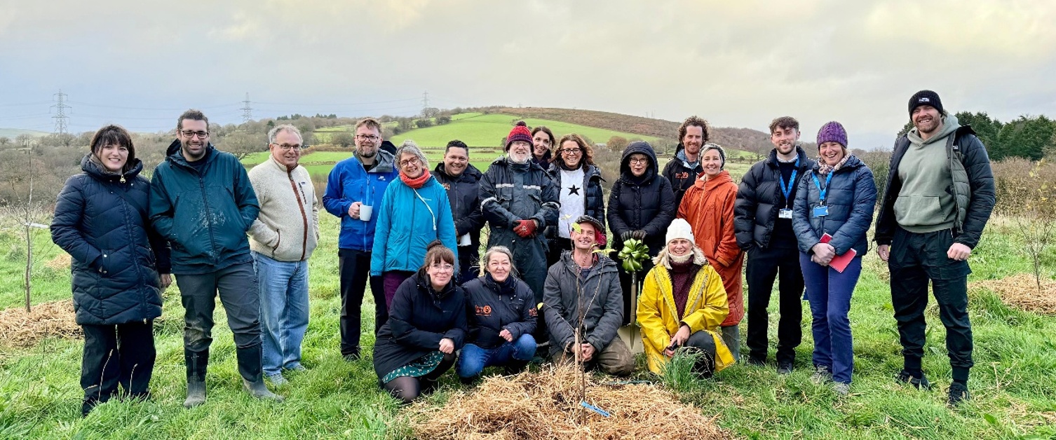 Image shows a group of people standing in a field