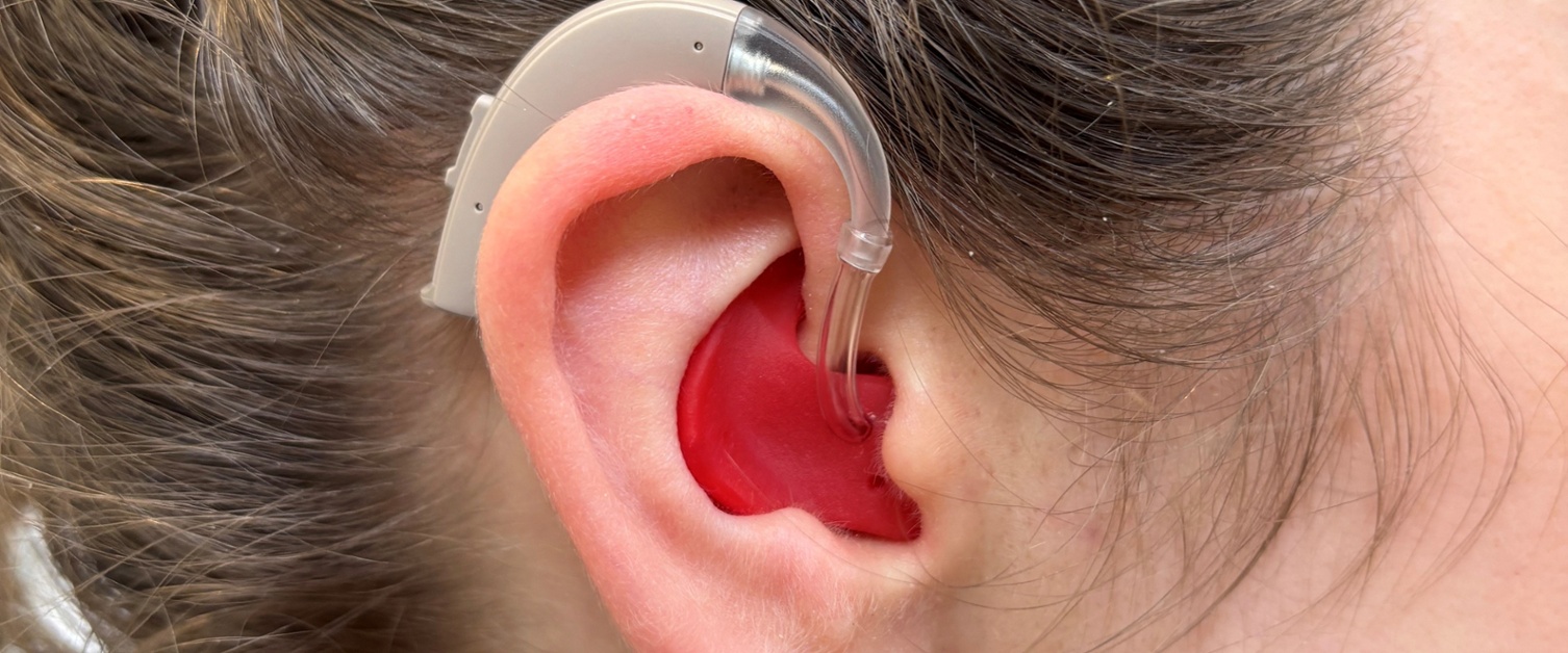 Image shows a hearing aid in a person