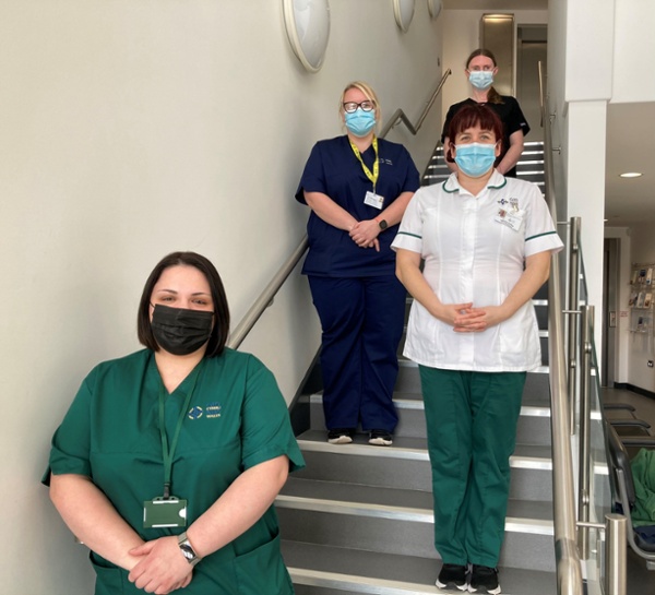 Members of the team stood on a staircase