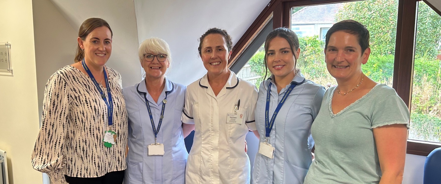 Members of staff stood in a GP practice