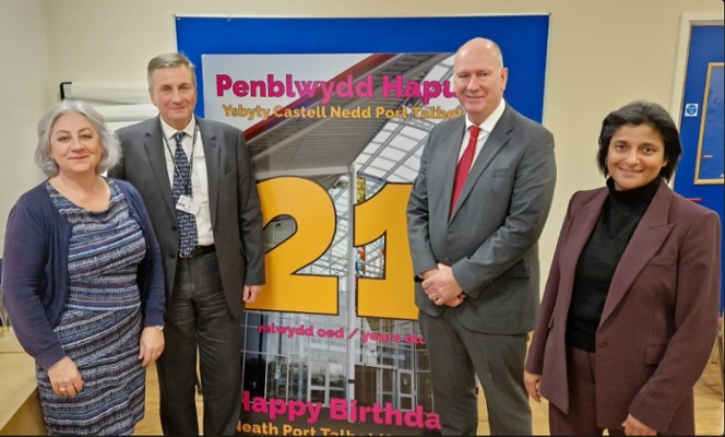 Image shows a group of people standing in a row