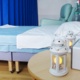 A double bed in the birth centre with lamps and radio on table.