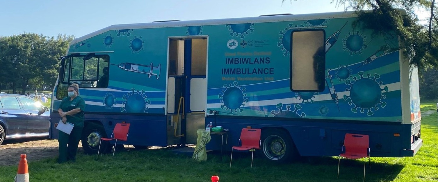 Swansea Bay UHB's mobile vaccination unit the Immbulance is parked in a field at Singleton Park.