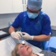 Nurse carries out eye procedure on patient