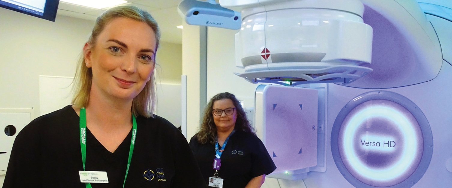 Image shows two radiotherapists in a radiotherapy treatment room