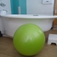 A birth centre pool with a birthing ball in front of it.