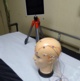 Pictured is the home video telemetry equipment, which consists of a tablet device mounted on a tripod, and a small EEG box with sensors which attach to patients