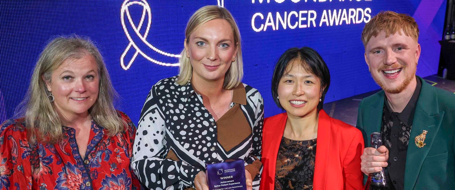 Image shows a group of people at an awards ceremony.
