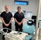 Richard and Lyndon stood next to dental equipment