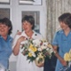 Image shows three women holding flowers
