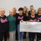 Image shows a group of women holding a large cheque.