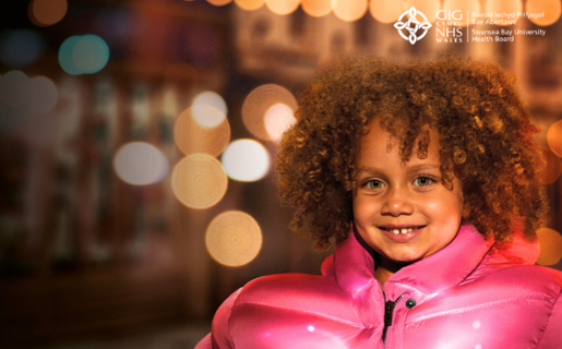 An image of a young girl wearing a big pink winter coat.