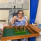 Image shows a woman sitting on a chair while playing table skittles