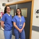 Image shows two women standing in a hospital corridor